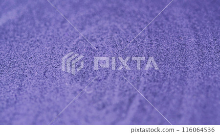 Wet glitter flow. Sparkling paint texture. Defocused purple color shiny metallic grain particles ink pigment fluid acrylic liquid spill abstract art background. Wet glitter flow. Sparkling paint texture. Defocused purple color shiny metallic grain particles ink pigment fluid acrylic liquid spill abstract art background. 116064536