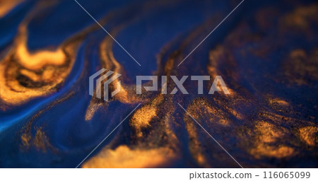 Ink spill. Glitter fluid mix. Defocused blue gold color glowing sparkling marble texture acrylic wave dark abstract art background. Ink spill. Glitter fluid mix. Defocused blue gold color glowing sparkling marble texture acrylic wave dark abstract art background. 116065099