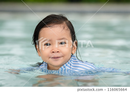 happy toddler baby float in swimming pool happy toddler baby float in swimming pool 116065664