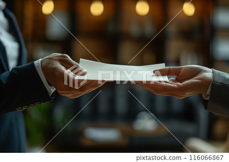A man is handing a piece of paper to a woman 116066867