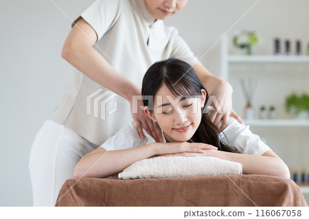 A young woman receiving a massage 116067058