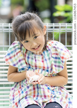 girl hugging a small animal 116067453
