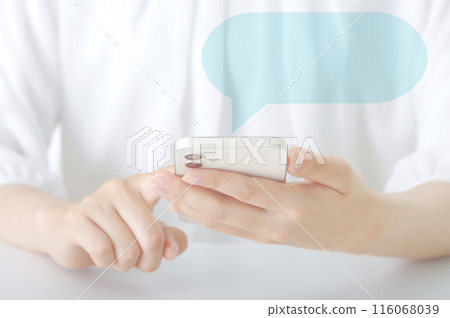 A woman exchanging messages on a smartphone 116068039
