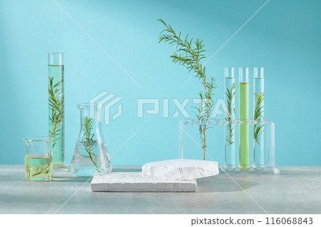 Creative template to design advertising pics for tea tree extract cosmetic, over the blue background. A large empty showcase pedestal for presentation, on the sides decorated with lab tools Creative template to design advertising pics for tea tree extract cosmetic, over the blue background. A large empty showcase pedestal for presentation, on the sides decorated with lab tools 116068843