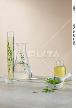 Minimalist style photo on yellow background, vacant space on the lab table for product displaying, which has natural ingredient as tea tree, decorated with experiment instruments 116068860