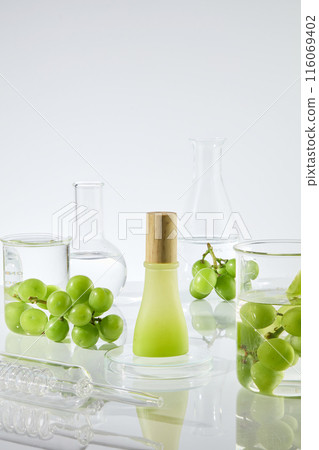 Mock up for advertising was shot diagonal view, with a blank label bottle of products made of grape seed extract, over the white texture, around of it decorated with lab glassware and fresh grape Mock up for advertising was shot diagonal view, with a blank label bottle of products made of grape seed extract, over the white texture, around of it decorated with lab glassware and fresh grape 116069402