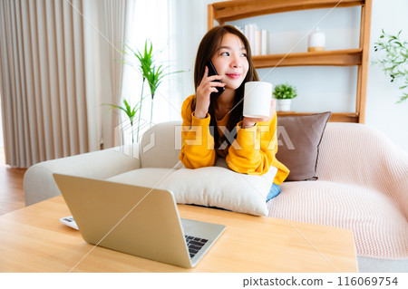 Young Asian female wearing glasses using laptop 116069754