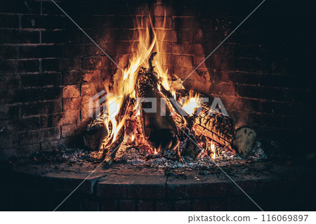 Wood burning fireplace, warm and cozy in cold weather outside the home Wood burning fireplace, warm and cozy in cold weather outside the home 116069897