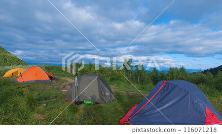 Four tents pitched in a scenic outdoor mountain setting. Group mountain hike. Four tents pitched in a scenic outdoor mountain setting. Group mountain hike. 116071218