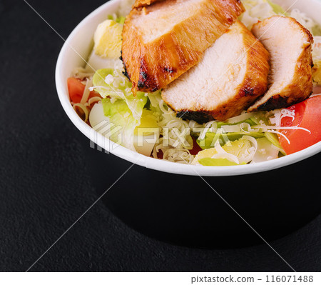 Delivery bowl with Caesar salad isolated on black 116071488