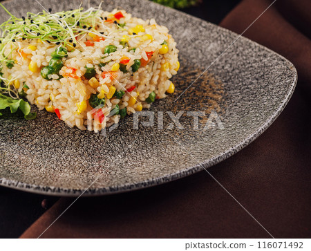 Bowl of rice with peas, corn and red peppers 116071492