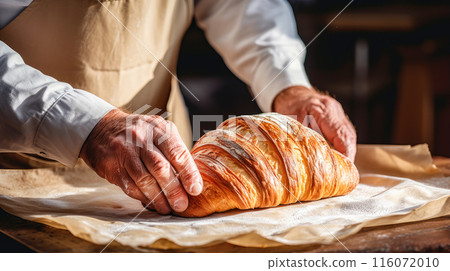 Baker's hands make Fresh aromatic bread with flour and dough on a wooden cutting board and wheat. Fresh classic pastries. 116072010