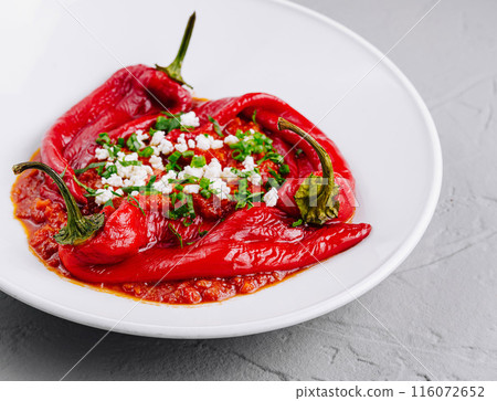Roasted red peppers with feta cheese on white plate 116072652