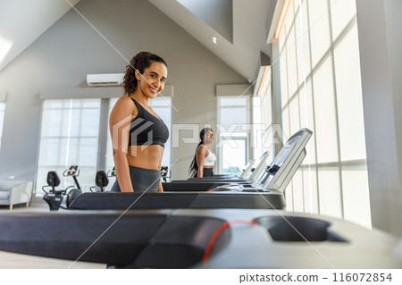 woman sportwear exercise running treadmill fitness in gym health club. 116072854