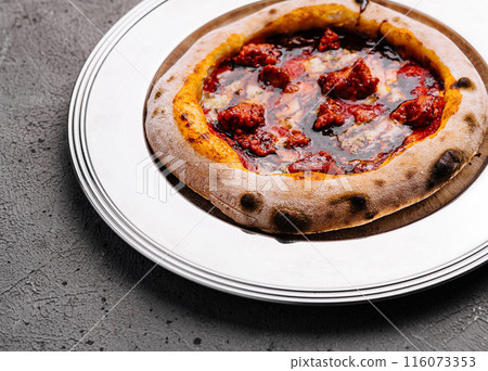 Artisan pepperoni pizza on white plate Artisan pepperoni pizza on white plate 116073353