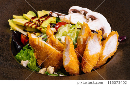 Gourmet fried chicken salad on elegant black plate Gourmet fried chicken salad on elegant black plate 116073402