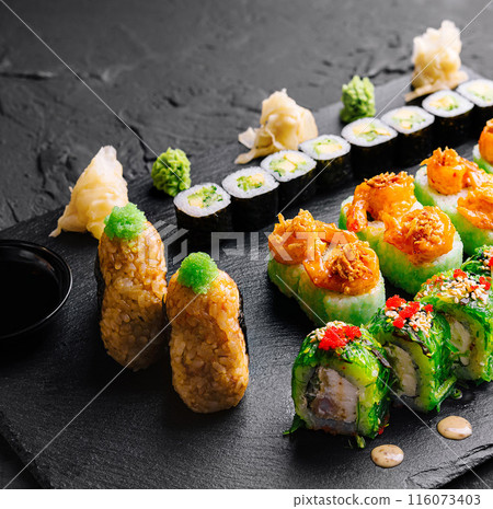 Assorted sushi platter on dark slate background Assorted sushi platter on dark slate background 116073403