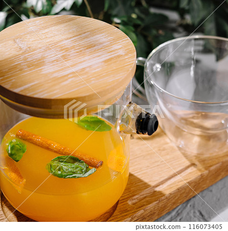 Refreshing orange detox water in glass pitcher Refreshing orange detox water in glass pitcher 116073405