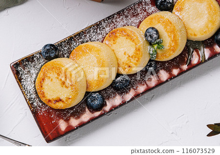 Elegant cottage cheese pancakes on plate 116073529