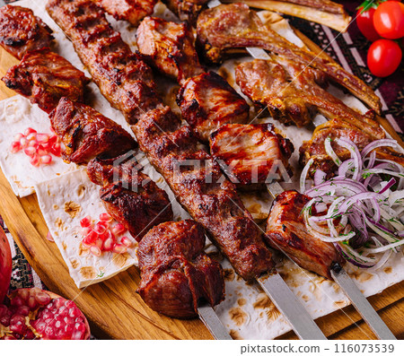 Traditional grilled shashlik skewers on wooden board 116073539
