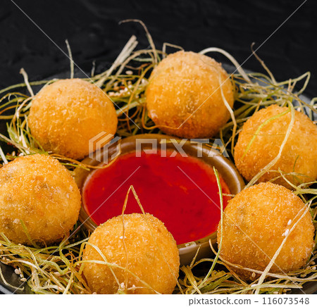 Crispy cheese balls with dip on hay nest Crispy cheese balls with dip on hay nest 116073548