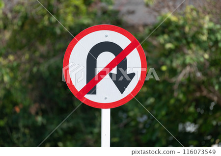 No right U-turn sign is on green background.selective focus. No right U-turn sign is on green background.selective focus. 116073549