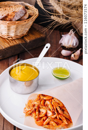 Gourmet cooked shrimp with dipping sauce on elegant plate Gourmet cooked shrimp with dipping sauce on elegant plate 116073574