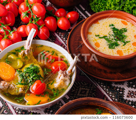 Traditional homemade soup served in earthenware bowls 116073600