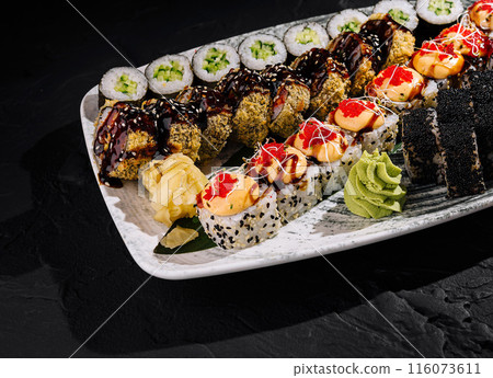 Assorted sushi platter on dark slate background Assorted sushi platter on dark slate background 116073611