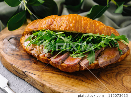 Gourmet croissant sandwich with arugula and ham Gourmet croissant sandwich with arugula and ham 116073613