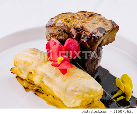 Gourmet steak and scalloped potatoes on plate 116073623