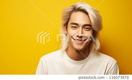 Portrait of a cute handsome happy Asian blond teenager guy with white long hair and perfect skin, yellow background, banner. 116073678