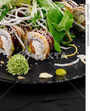 Exquisite sushi roll platter on dark slate 116074109
