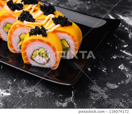 Gourmet sushi roll with caviar on dark plate Gourmet sushi roll with caviar on dark plate 116074172