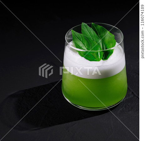 Fresh green cocktail with basil leaf garnish 116074189