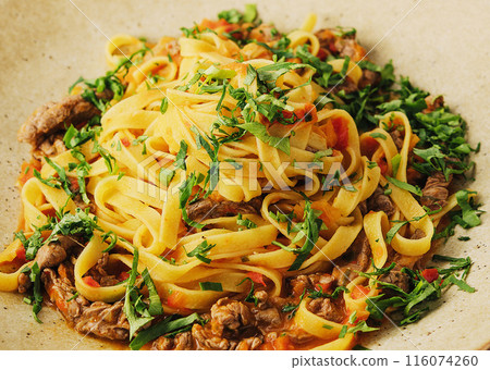 egg pasta tagliatelle with bolognese sauce made from meat and tomato sauce 116074260