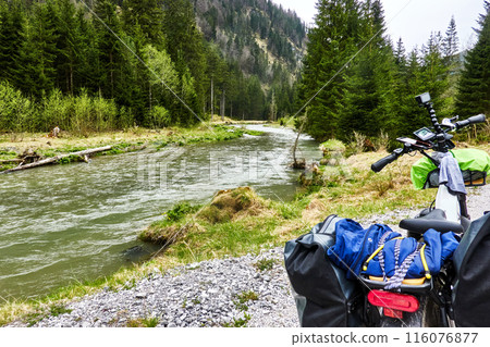 Bike touring adventure along a serene mountain river Bike touring adventure along a serene mountain river 116076877