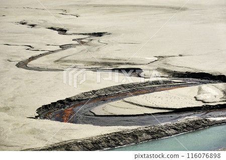 Winding river through barren landscape 116076898