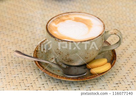 Cup of latte coffee and spoon on gray counter 3 116077140