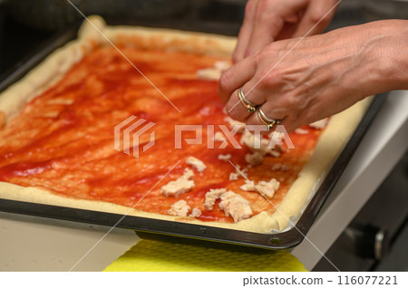 woman putting meat on pizza in the kitchen 3 woman putting meat on pizza in the kitchen 3 116077221