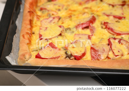 freshly baked pizza with cheese, tomatoes and chicken fillet 7 116077222