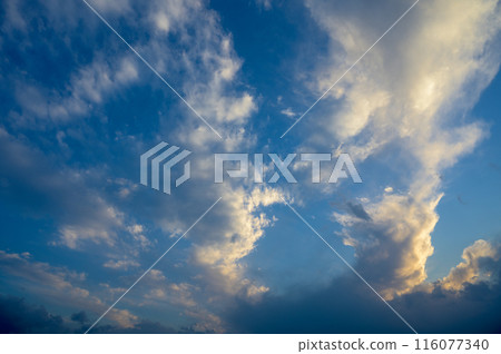 The gathering clouds during sunset create abstract painting patterns in the western sky. 3 116077340
