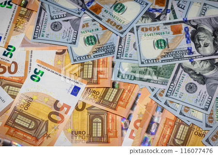 Exchange, cash. One hundred US dollar banknote among euro banknotes in closeup photography for foreign exchange market concept. 116077476