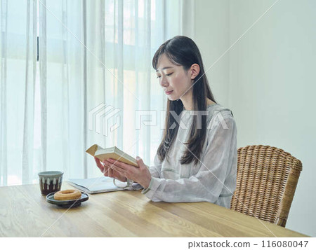 A woman reading A woman reading 116080047