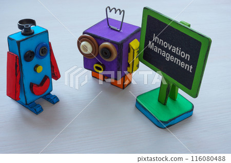 Two funny robots and innovation management sign. 116080488