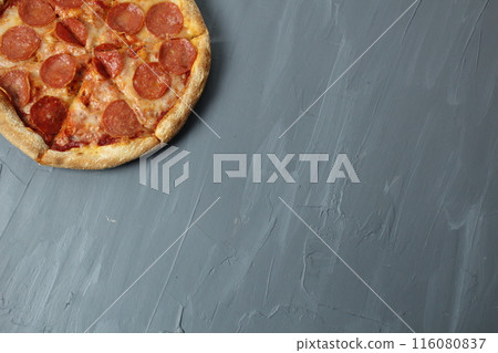 pizza pepperoni on a gray background top angle with space for text copyspace 116080837