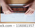 Hands using an abacus 116081357