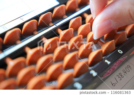 Hands using an abacus 116081363