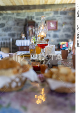 A table with a candle and a glass of red wine 116082242