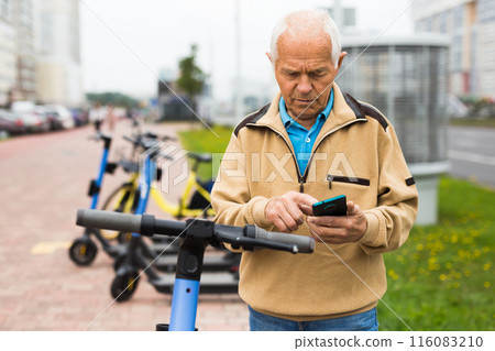 Old man using smartphone to activate e-scooter Old man using smartphone to activate e-scooter 116083210
